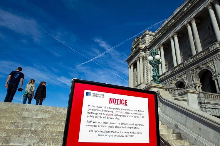 Close up of a sign disclaiming the closing of the library of congress in front of the library of congress